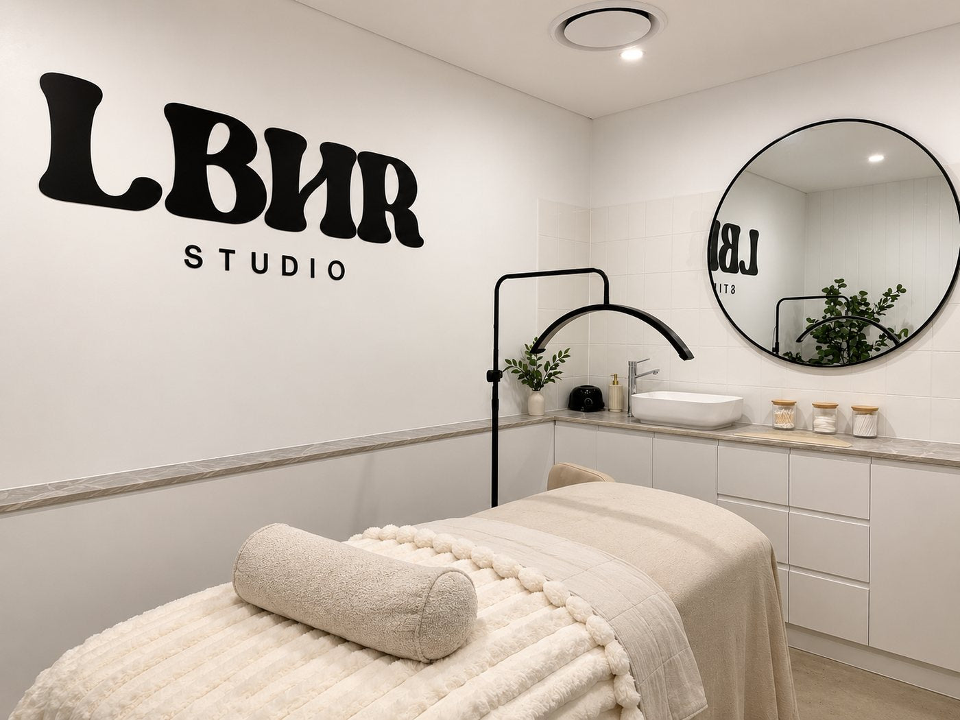 LBHR Studio private lash room with treatment bed and LBHR Studio wall sign